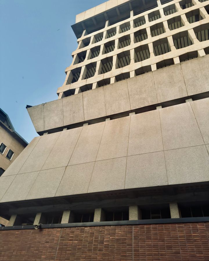 A tall concrete commercial building in Lusaka